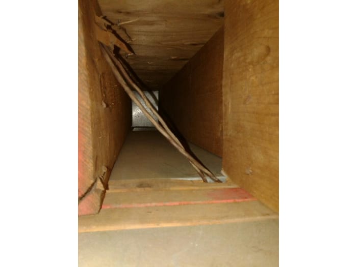 Technician performing professional air duct cleaning with advanced vacuum equipment to improve indoor air quality.